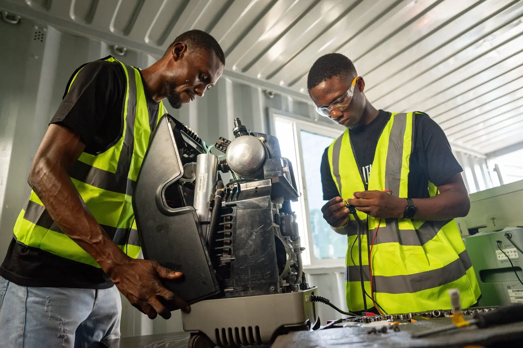 HealthPort technicians servicing a compressor inside the plant